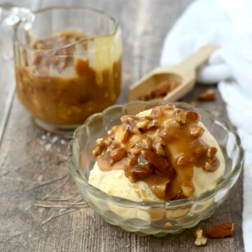 A serving of pecan praline sauce on top of ice cream.