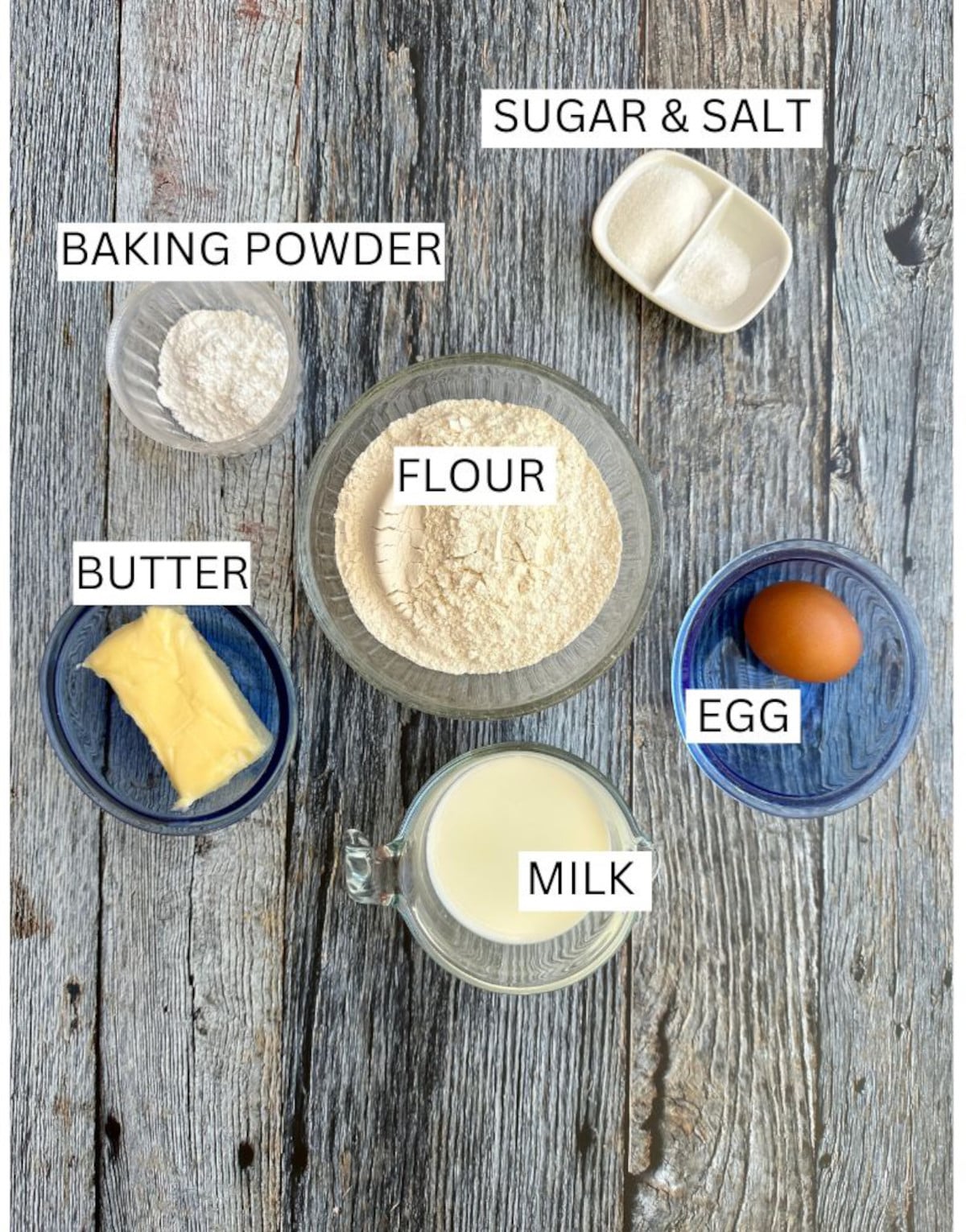 Homemade biscuit ingredients on a wooden table.