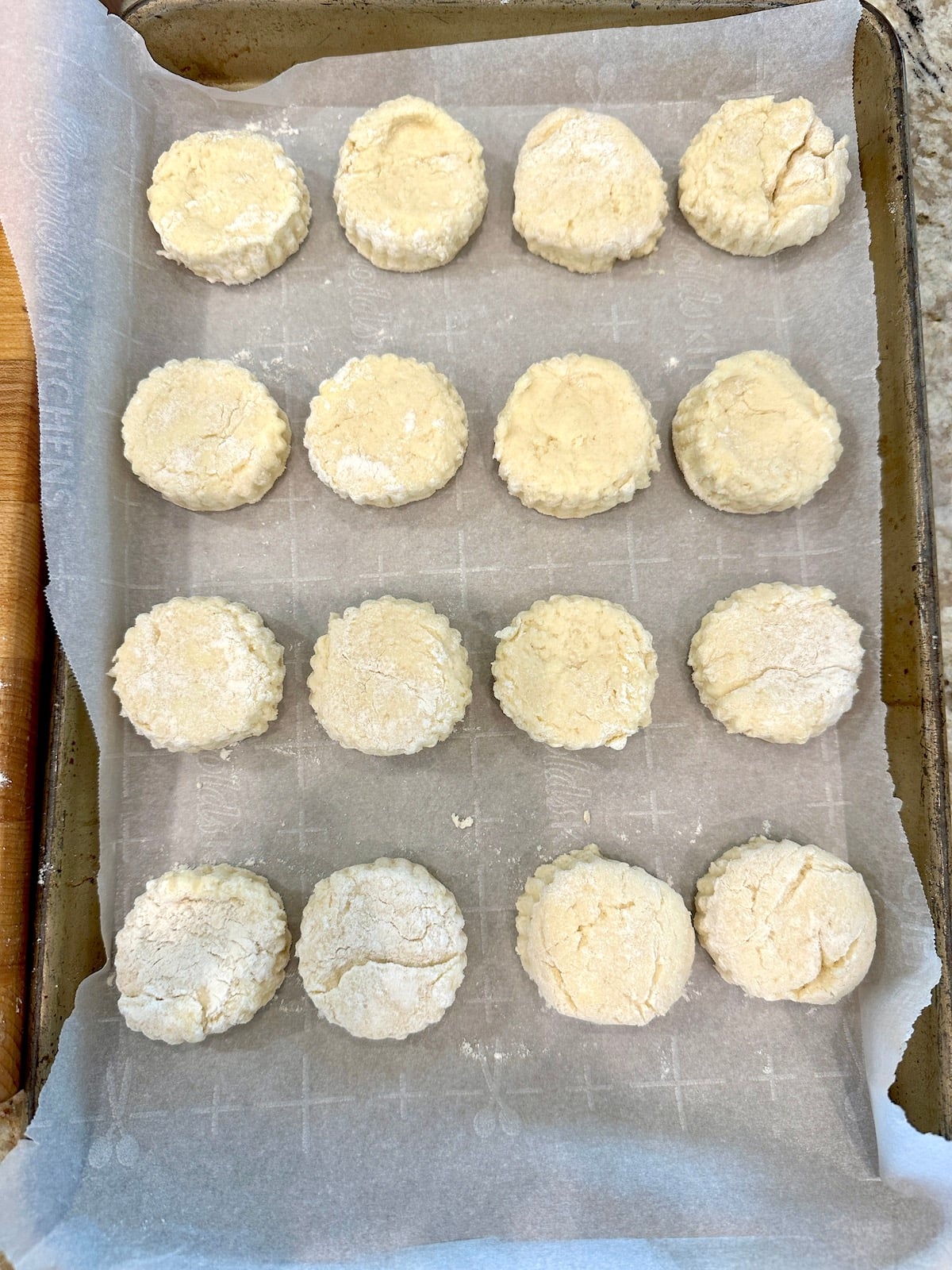 Unbaked biscuits on a baking sheet.