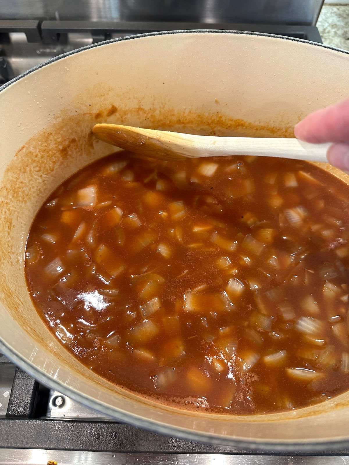 Broth for pot roast with vegetables in a Dutch oven,