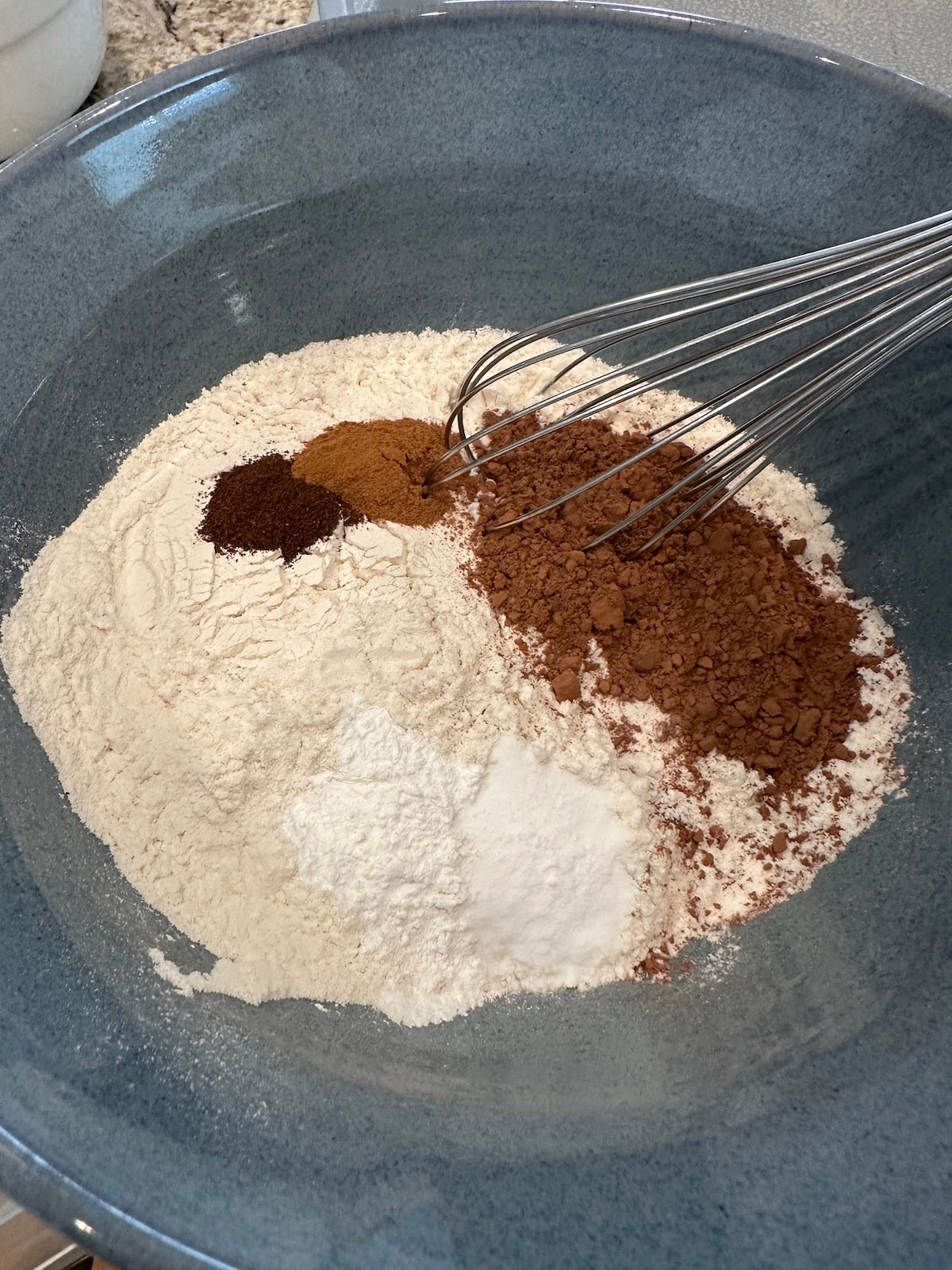 Dry ingredients for the summer dessert, chocolate zucchini cake, in a bowl.