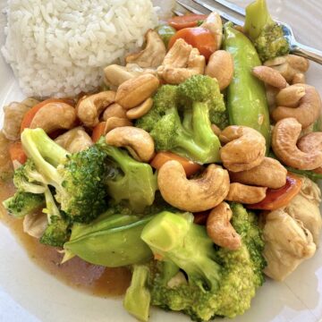 A serving of cashew chicken stir fry with rice.