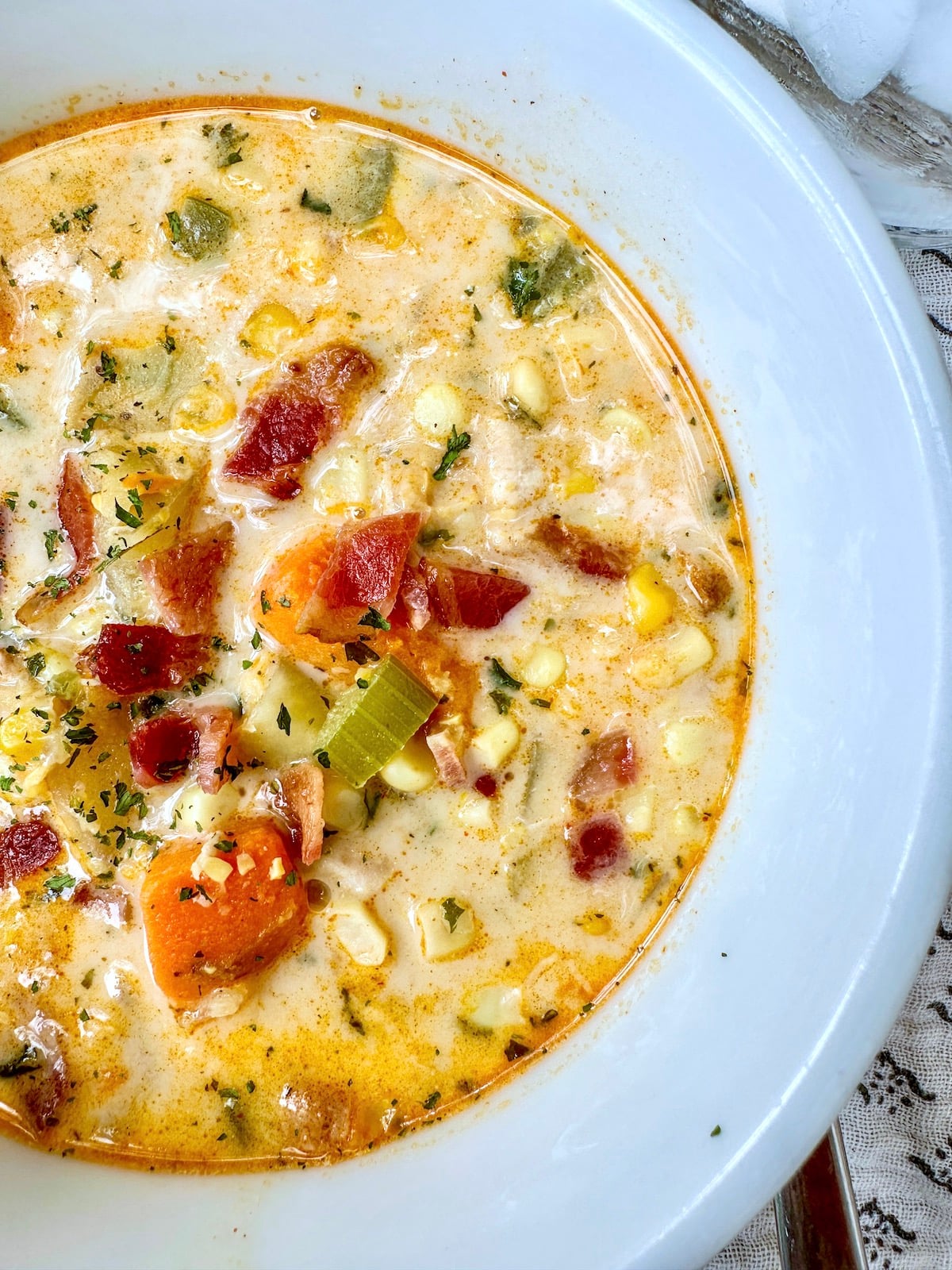 Corn soup with cream sauce and sweet potatoes in a soup bowl.