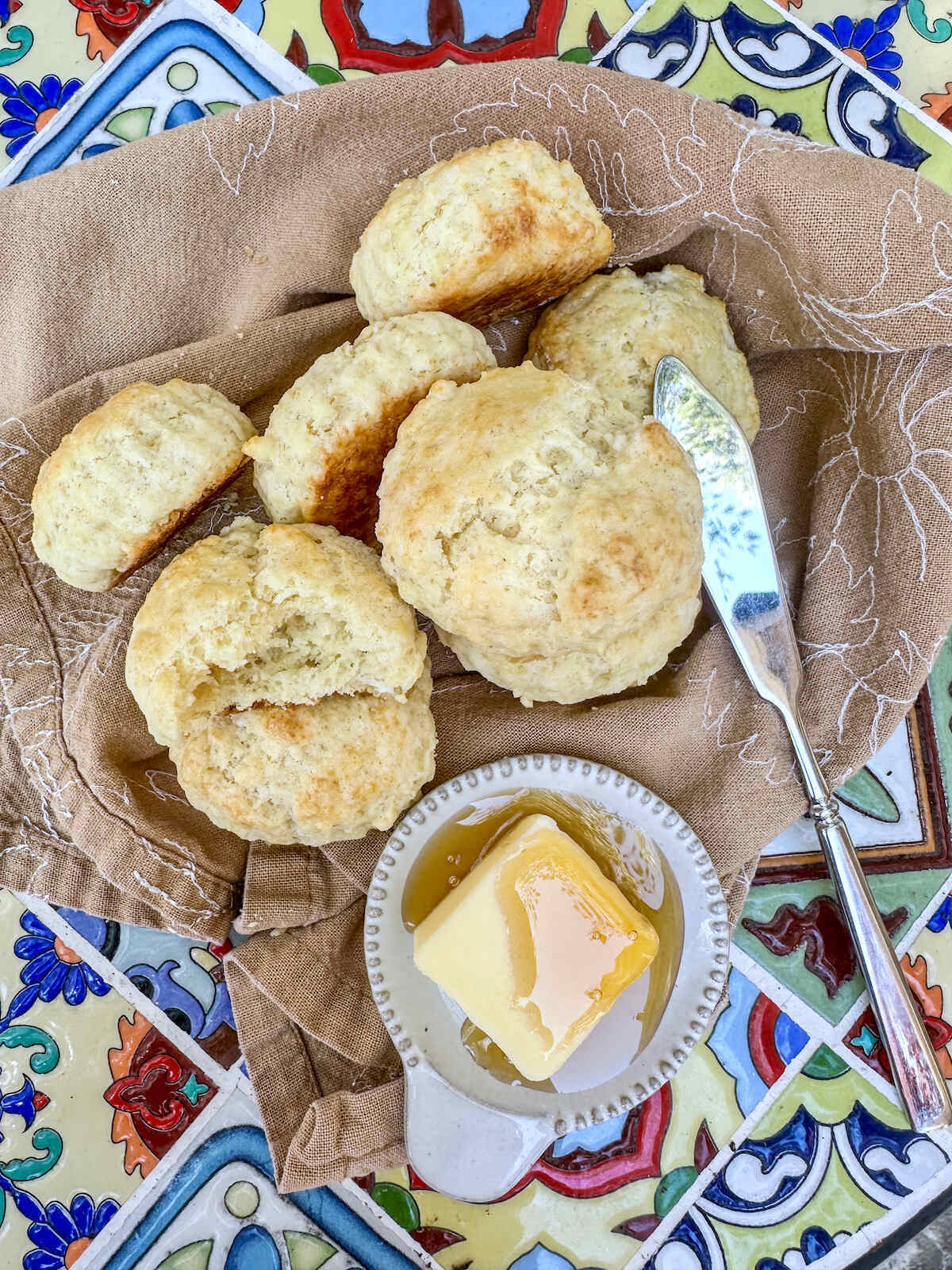 Homemade biscuits with butter and honey.