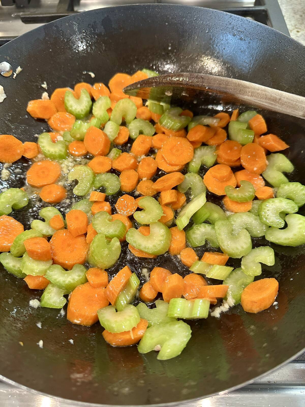 Celery and carrots in a pan.