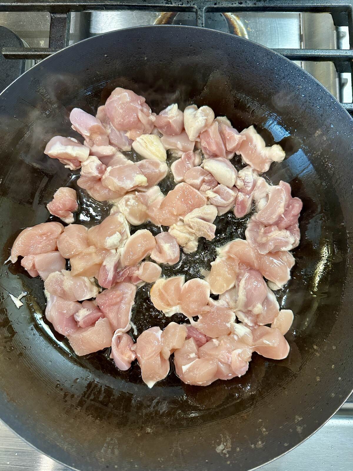 Chicken cooking in a pan.