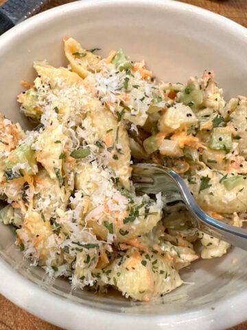 Pasta salad with Italian dressing in a bowl with a fork.