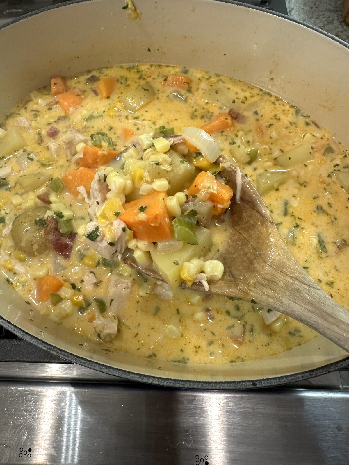 Corn and potato soup in a pan.